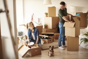 couple packing their items in moving boxes