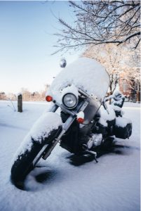 motorcycle in the snow needing to be stored safely