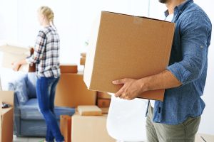 man holding moving boxes