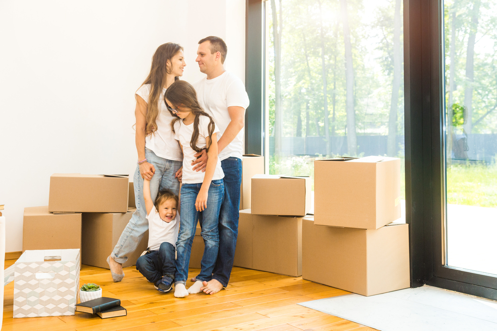 family moving boxes to new home