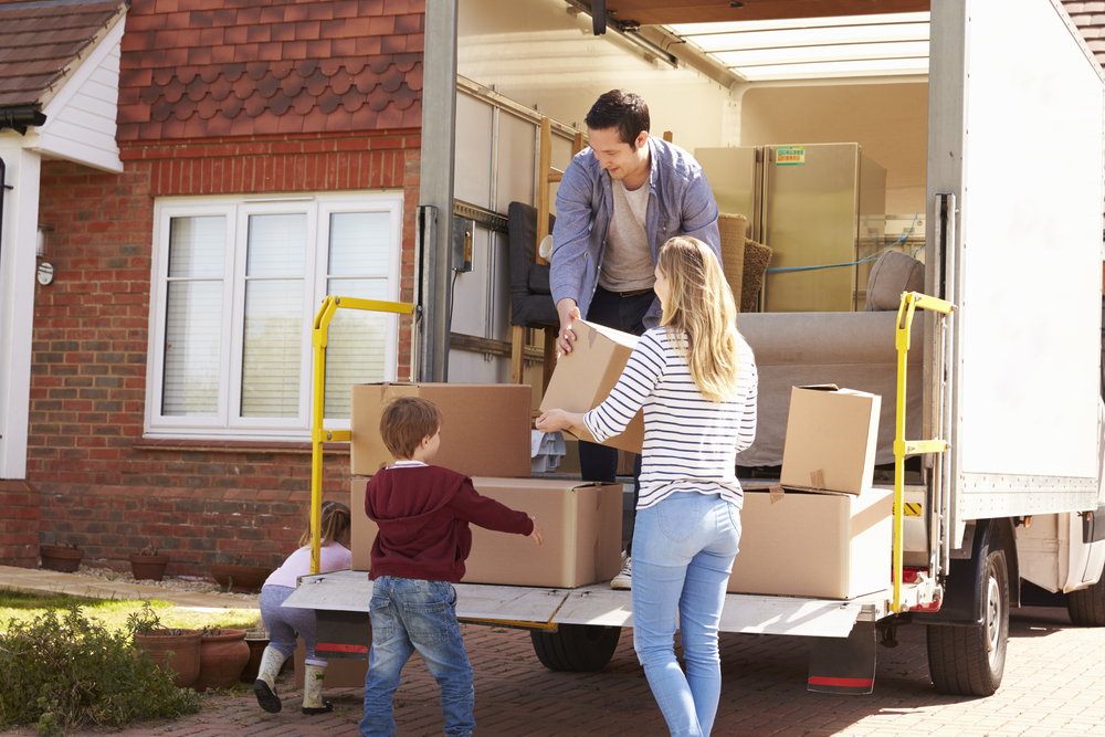 family moving boxes to new home