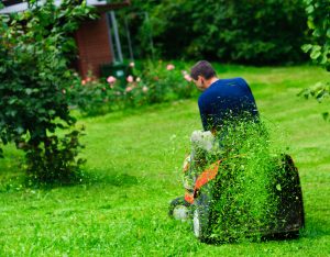 man riding lawn mower