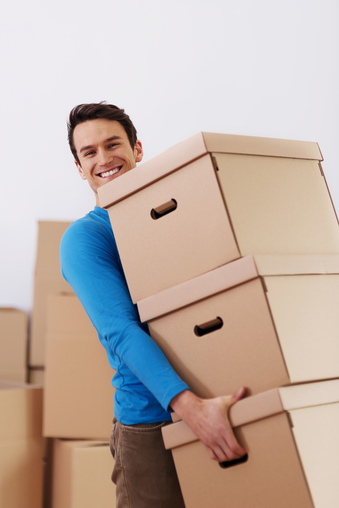 man carries boxes into self storage unit